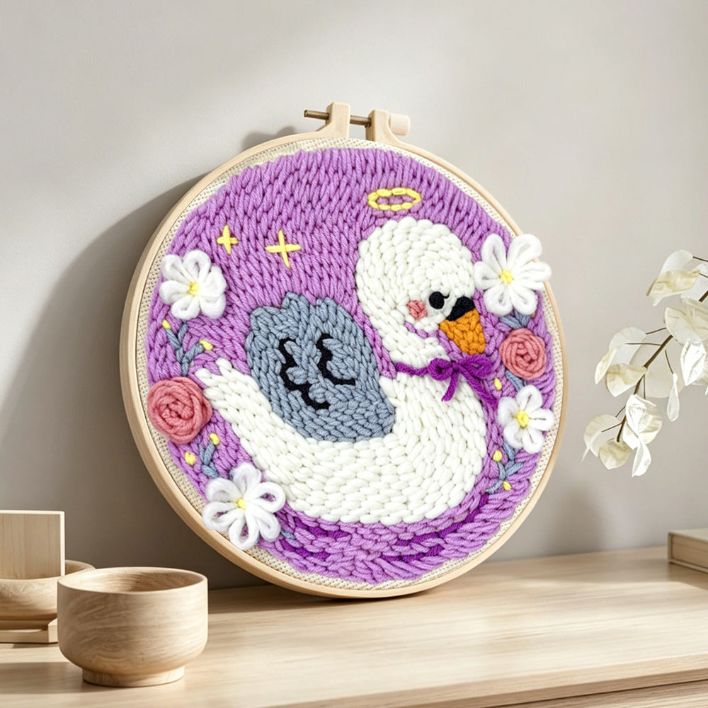 Angel swan and flowers punch needle artwork displayed on a table