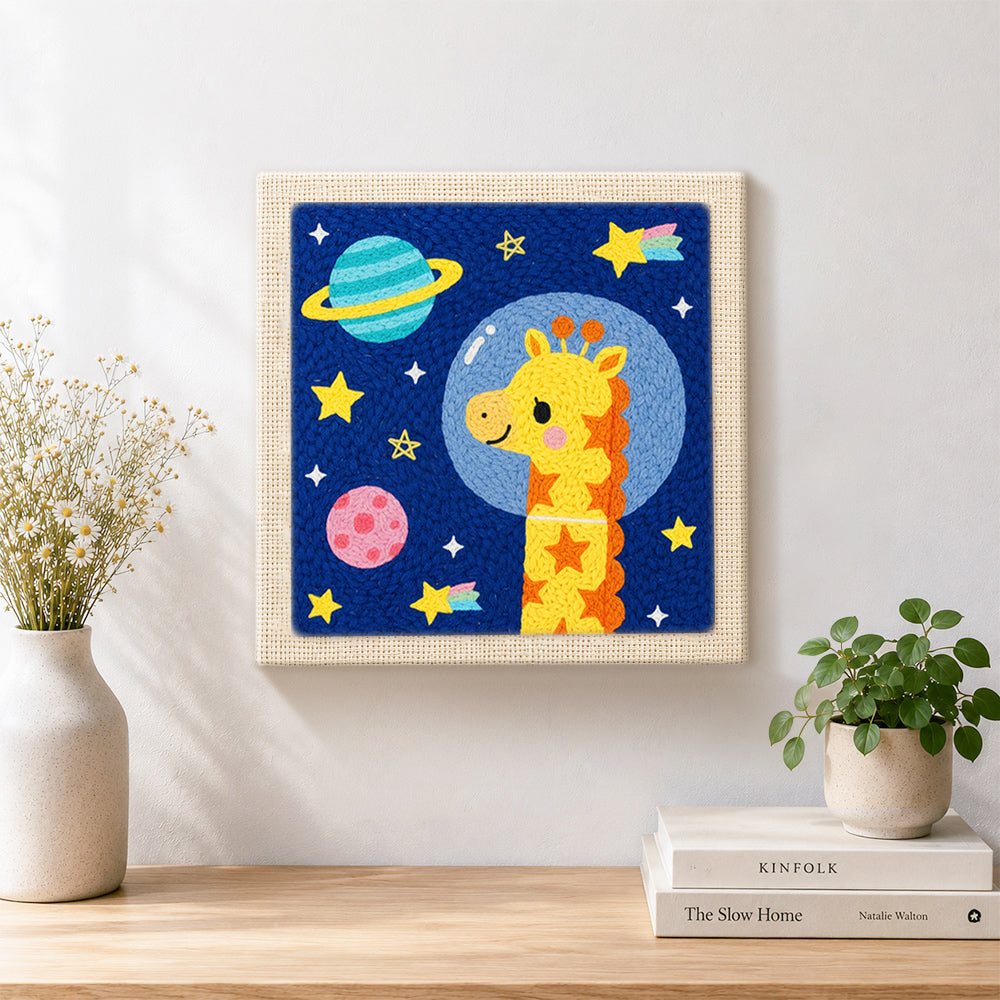 Finished astronaut giraffe with planets artwork displayed on a wall