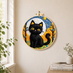 Autumn black cat needle felt wall art displayed in a bright home interior