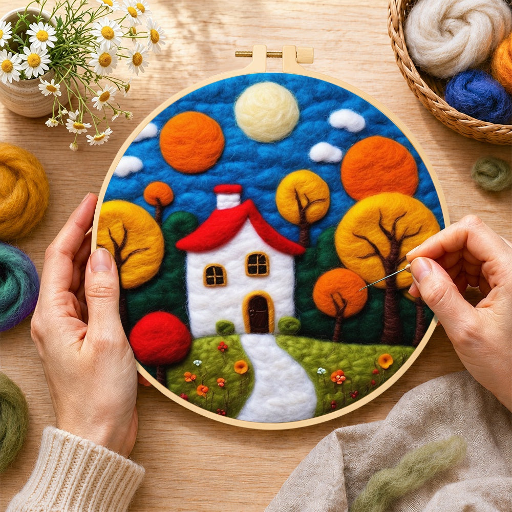Creating the autumn fairy tale tree and house wool painting by hand with a felting needle