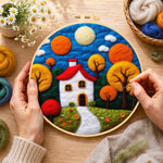 Creating the autumn fairy tale tree and house wool painting by hand with a felting needle