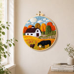 Autumn farm scene needle felt wall art displayed in a bright home interior