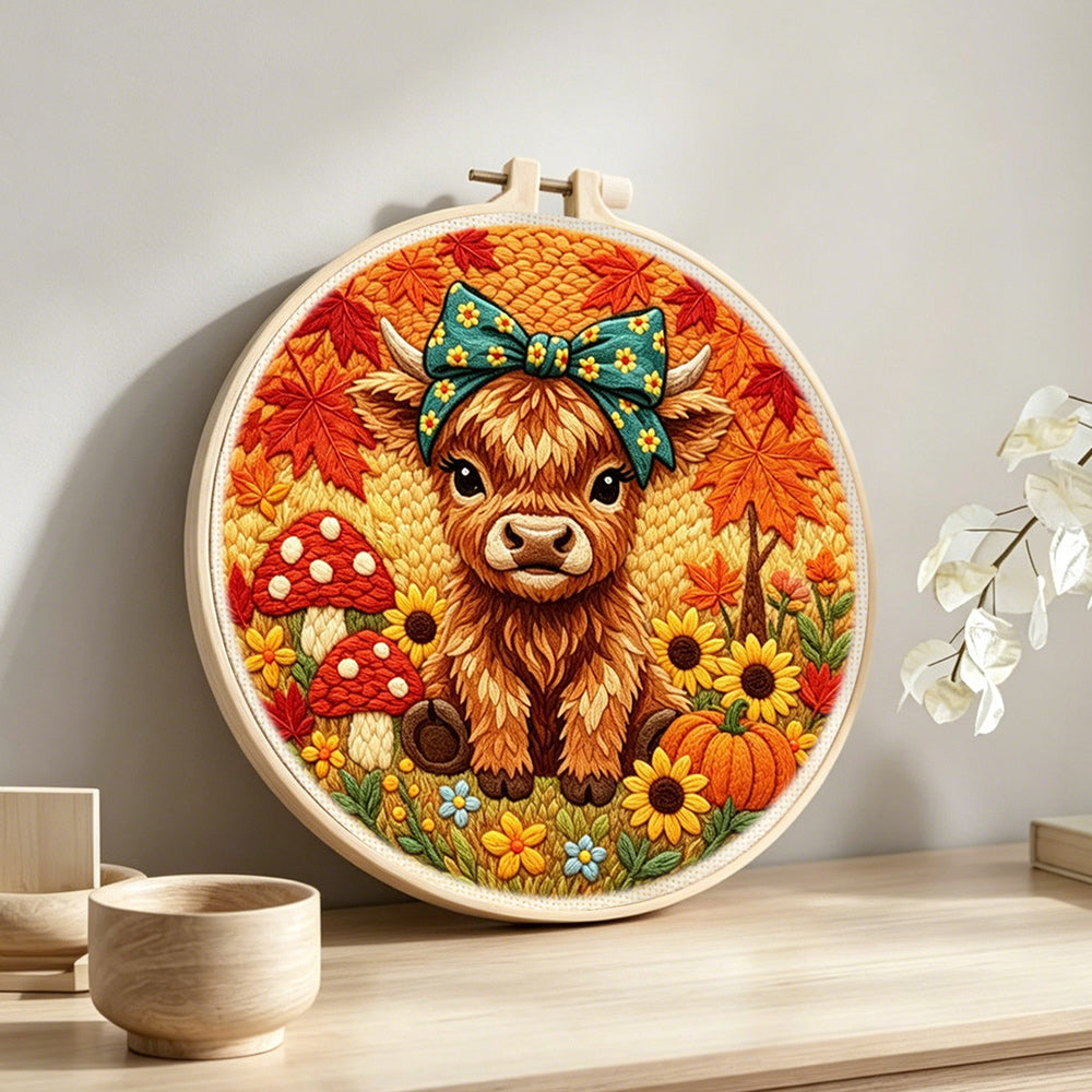 Autumn harvest highland cow punch needle artwork displayed on a table
