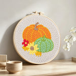Autumn harvest pumpkins punch needle artwork displayed on a table