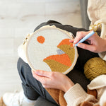 Creating handmade autumn mountain with sun punch needle artwork