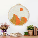 Finished autumn mountain with sun artwork displayed on a wall