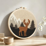 Autumn mountains and deer punch needle artwork displayed on a table