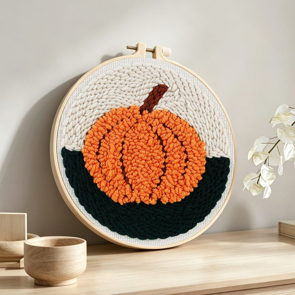 Autumn orange pumpkin punch needle artwork displayed on a table
