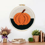 Finished autumn orange pumpkin artwork displayed on a wall