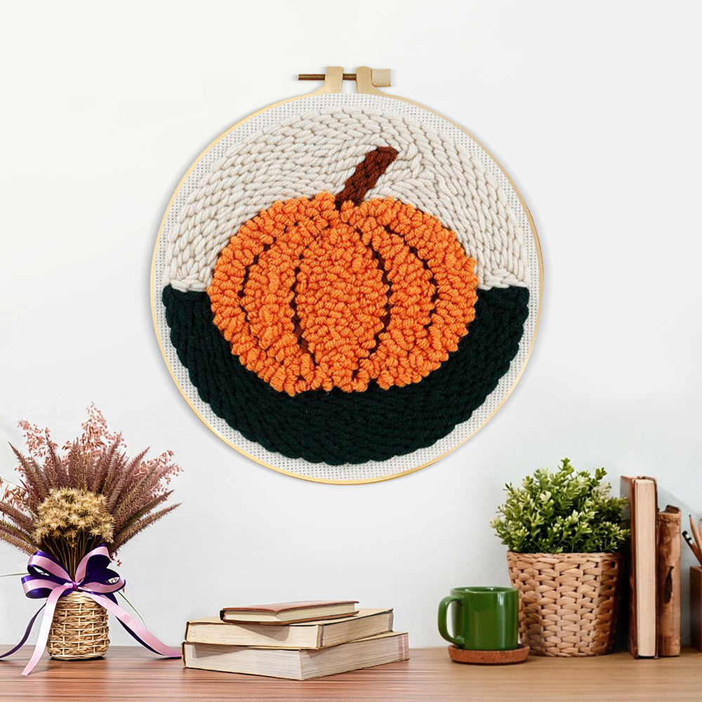 Finished autumn orange pumpkin artwork displayed on a wall