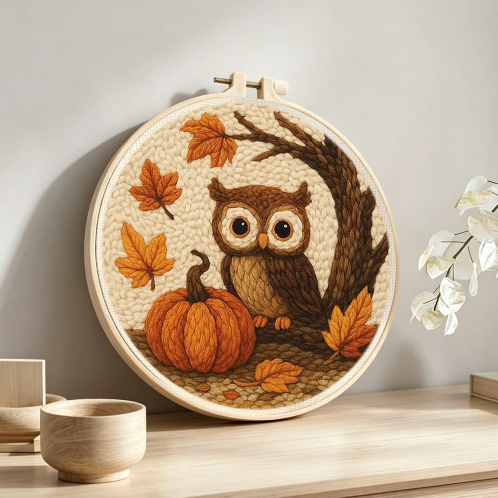 Autumn pumpkin and owl punch needle artwork displayed on a table