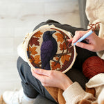 Creating handmade autumn raven punch needle artwork