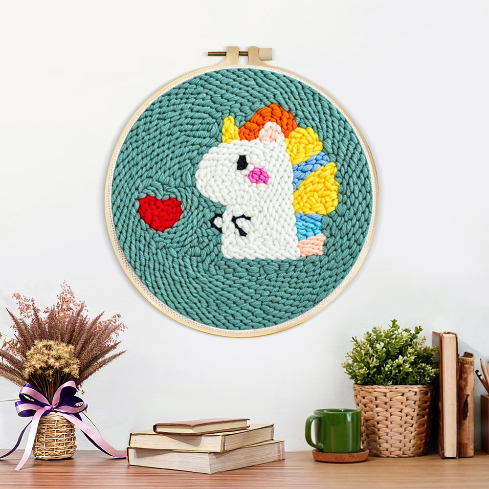 Finished baby dinosaur and red heart artwork displayed on a wall