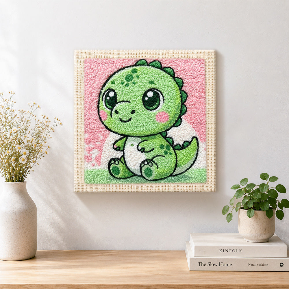 Finished baby green dinosaur with big eyes artwork displayed on a wall