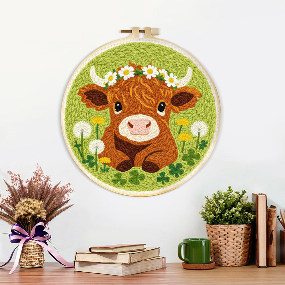 Finished baby highland cow and dandelions artwork displayed on a wall