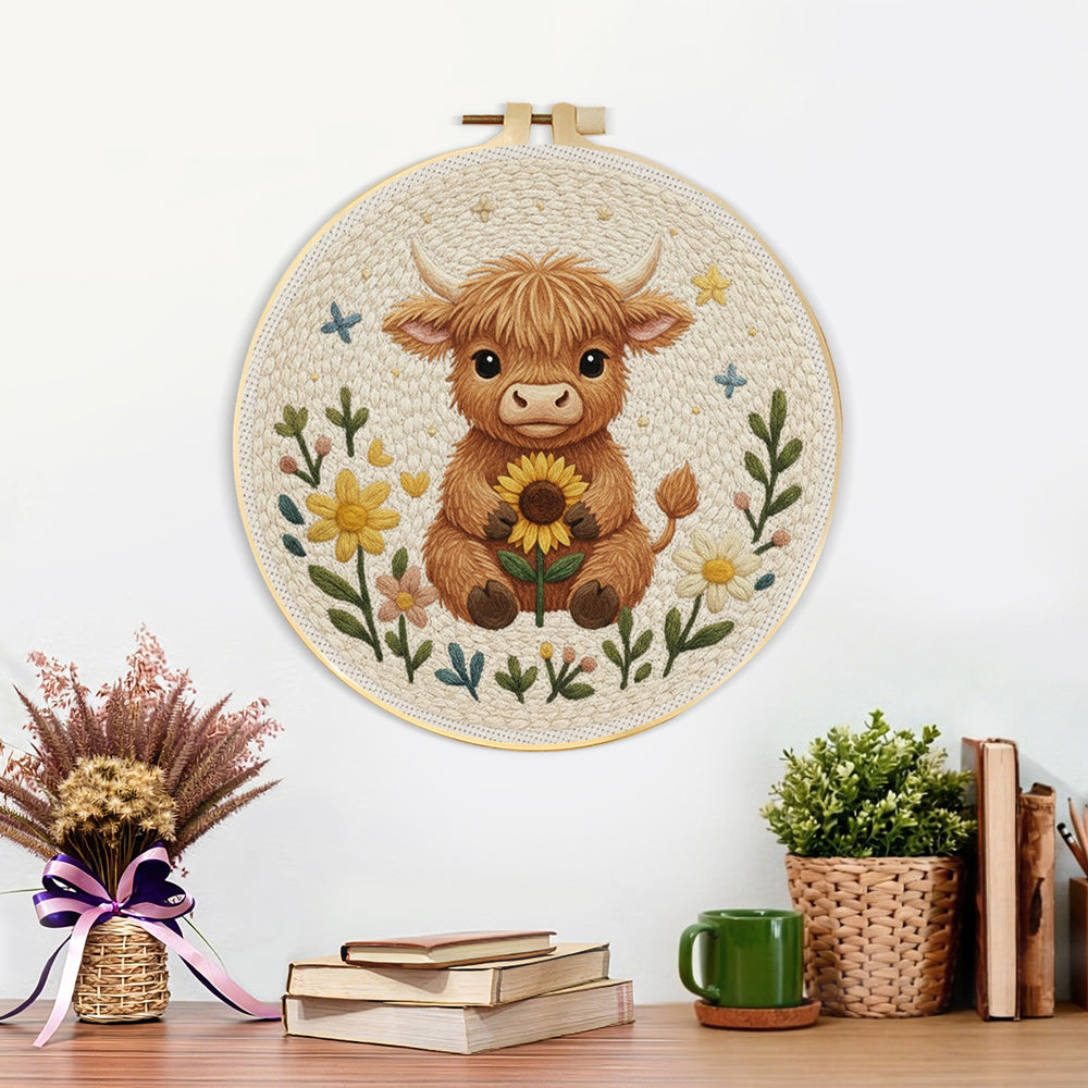 Finished baby highland cow and sunflower artwork displayed on a wall