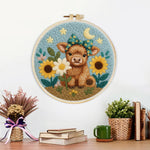 Finished baby highland cow and sunflowers artwork displayed on a wall