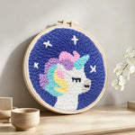 Baby unicorn punch needle artwork displayed on a table