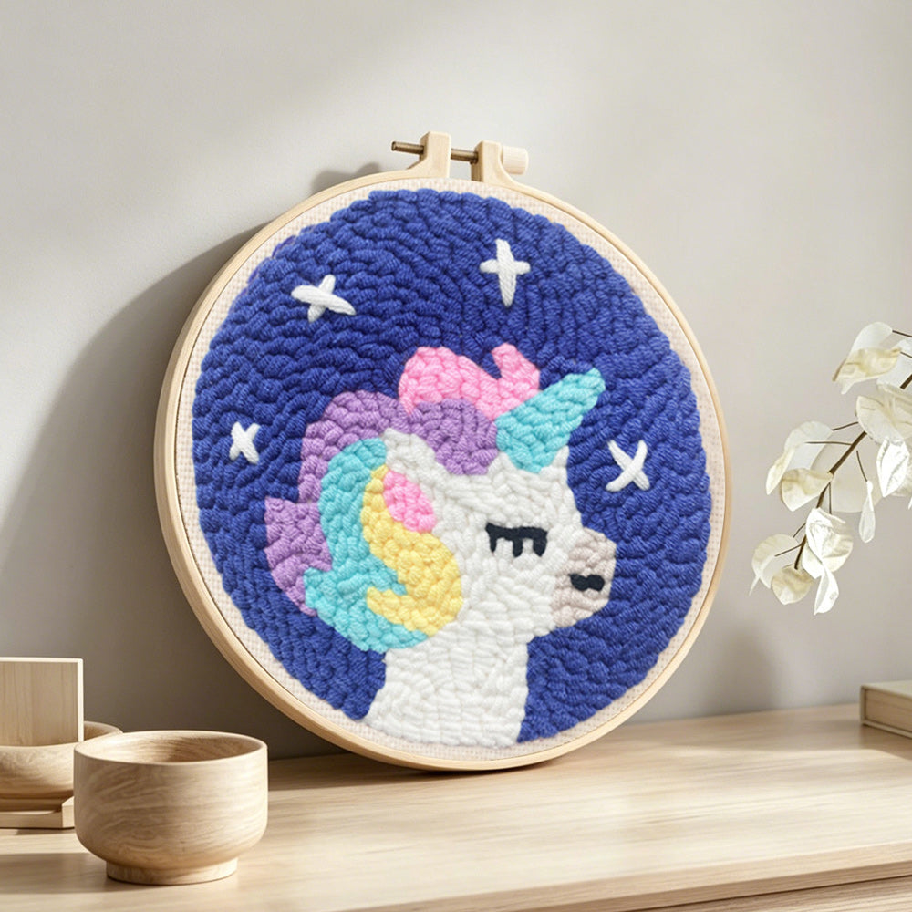 Baby unicorn punch needle artwork displayed on a table