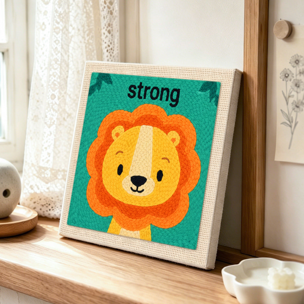 Be strong little lion punch needle artwork displayed on a table