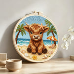 Beach highland cow punch needle artwork displayed on a table