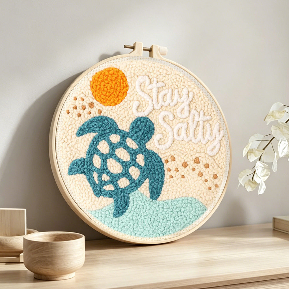 Beach turtle punch needle artwork displayed on a table