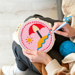 Creating handmade beach umbrella on sand punch needle artwork