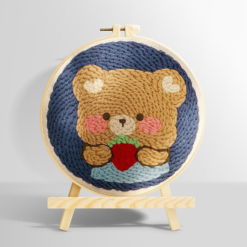 Bear holding strawberry punch needle kit for beginners