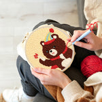 Creating handmade bear with balloon and party hat punch needle artwork