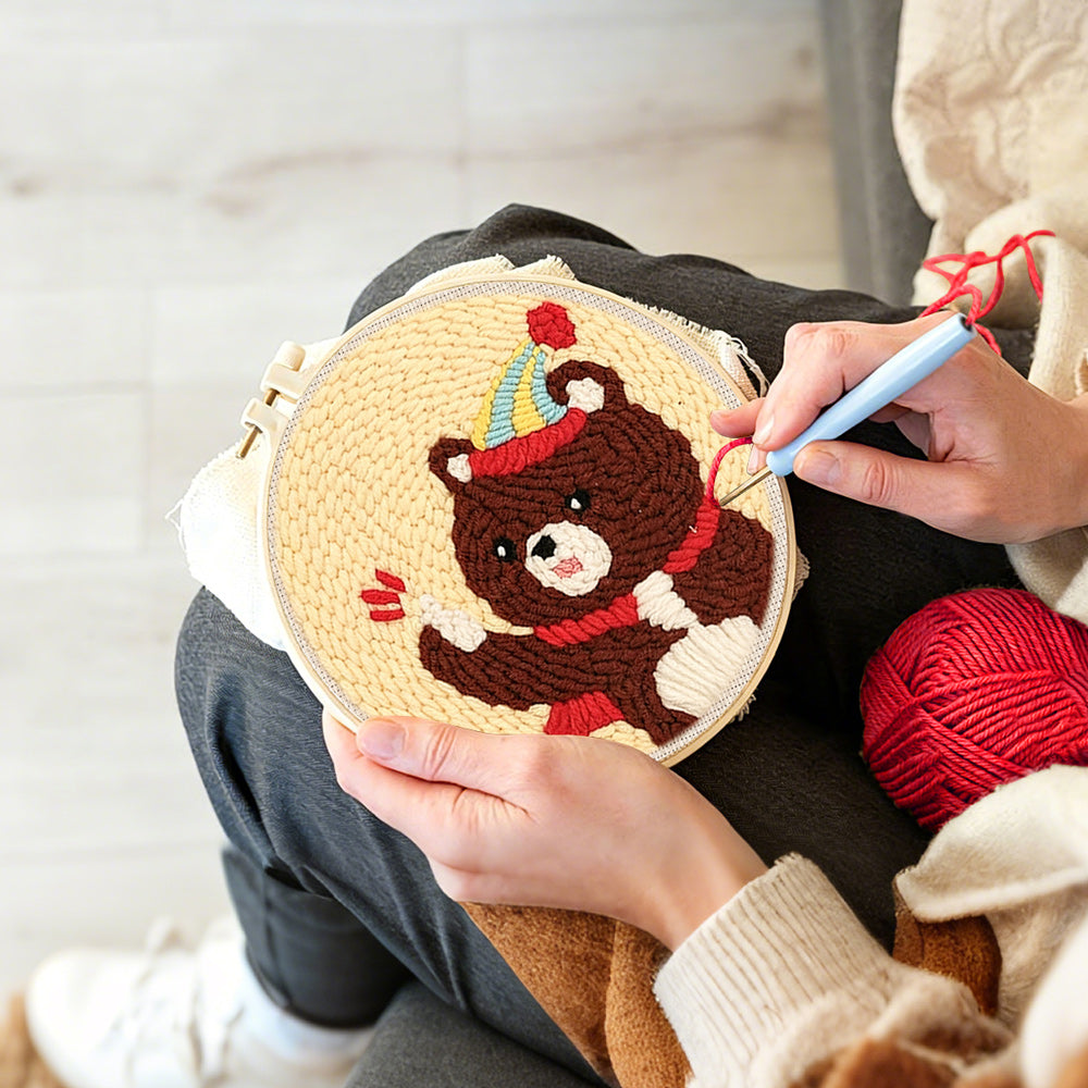 Creating handmade bear with balloon and party hat punch needle artwork