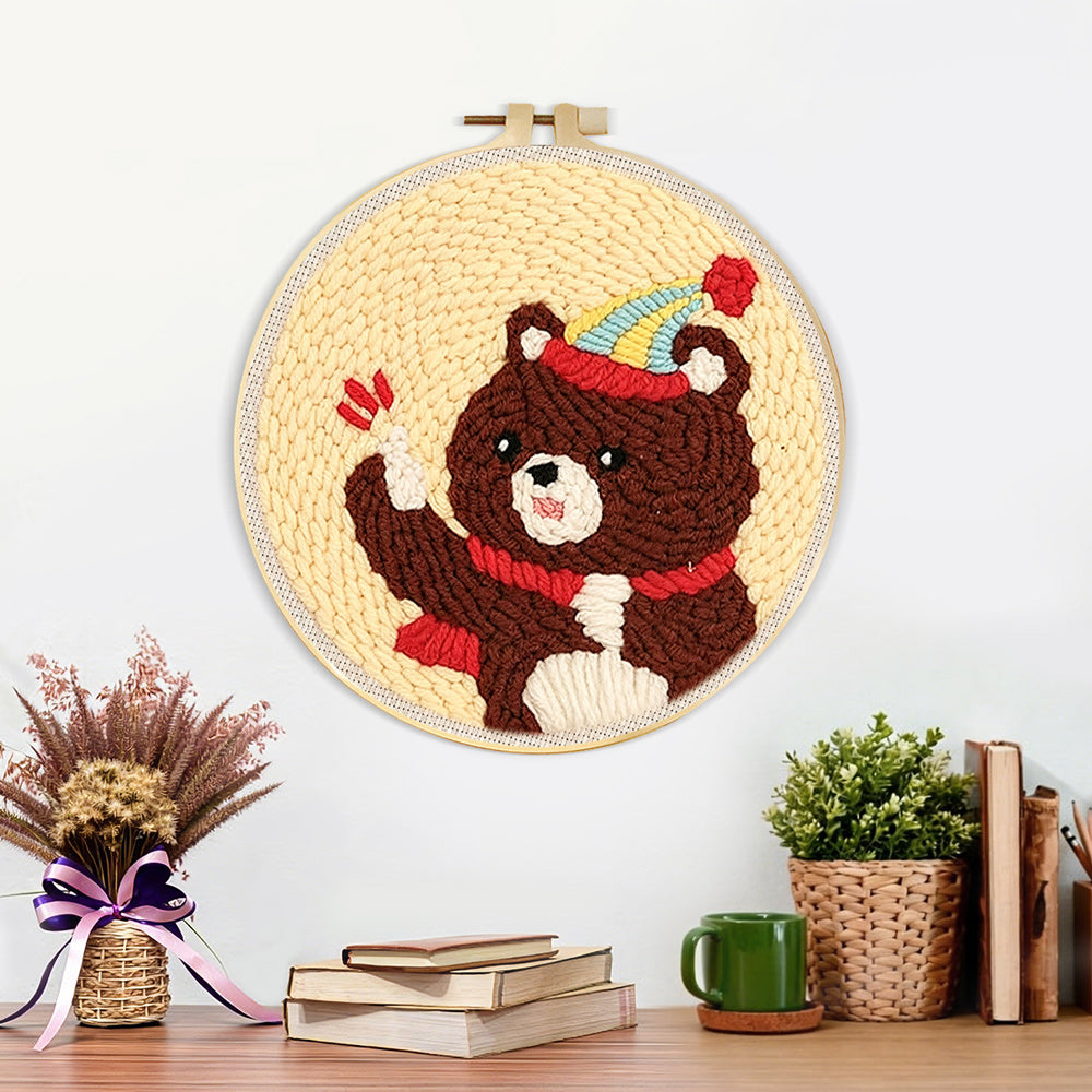 Finished bear with balloon and party hat artwork displayed on a wall