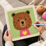 Creating handmade bear with yellow heart punch needle artwork