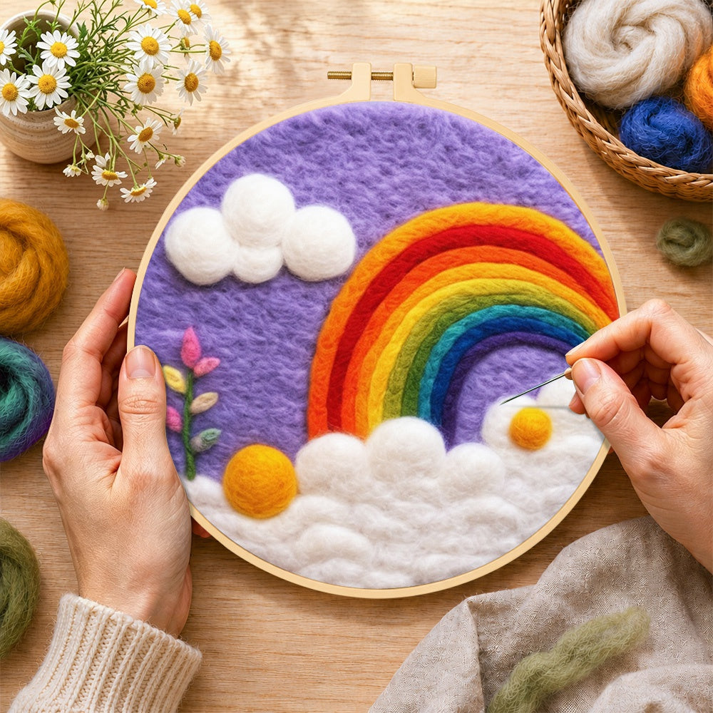 Creating the beautiful rainbow and white clouds in the purple sky wool painting by hand with a felting needle