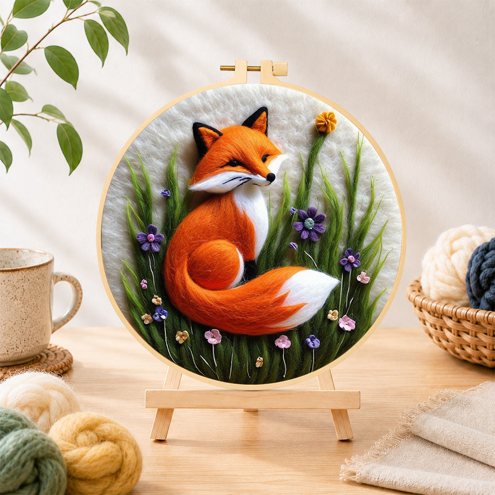Finished beautiful red fox and purple wildflowers needle felting displayed on a wooden easel