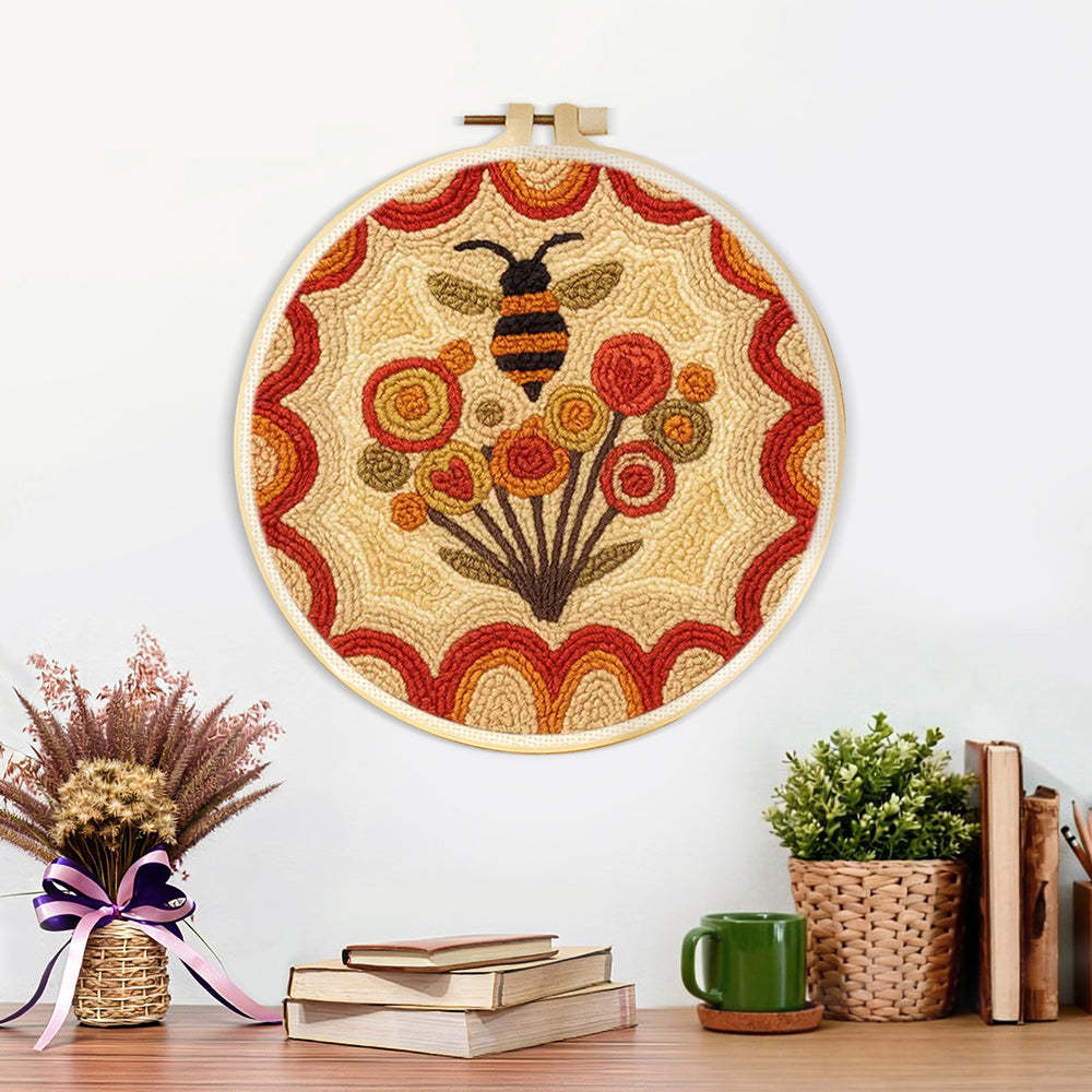 Finished bee and dandelions artwork displayed on a wall