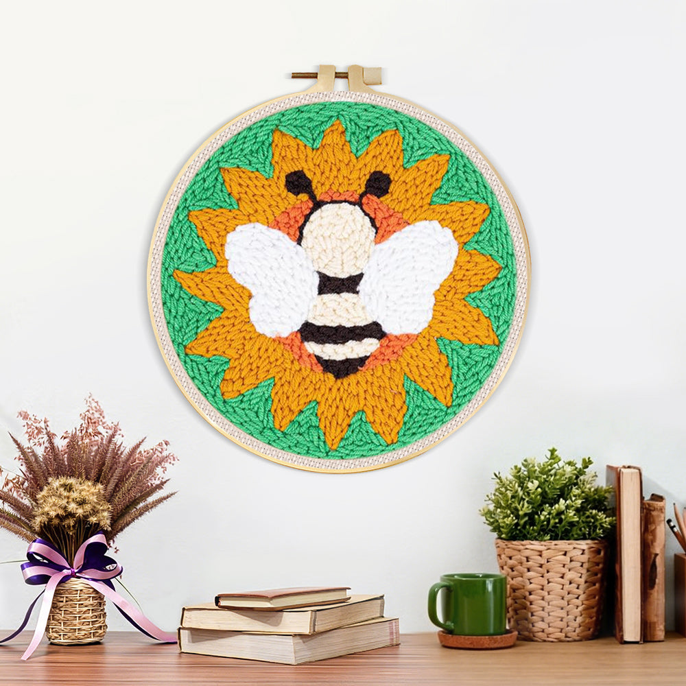 Finished bee and sunflower artwork displayed on a wall