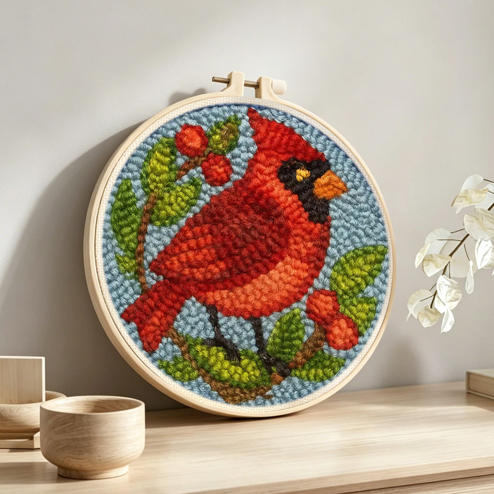 Berry cardinal punch needle artwork displayed on a table