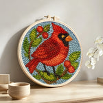 Berry cardinal punch needle artwork displayed on a table