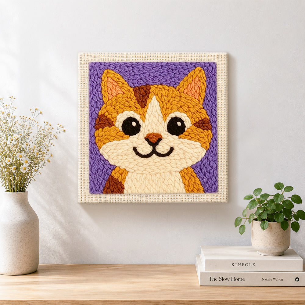 Finished big-eyed orange tabby cat artwork displayed on a wall