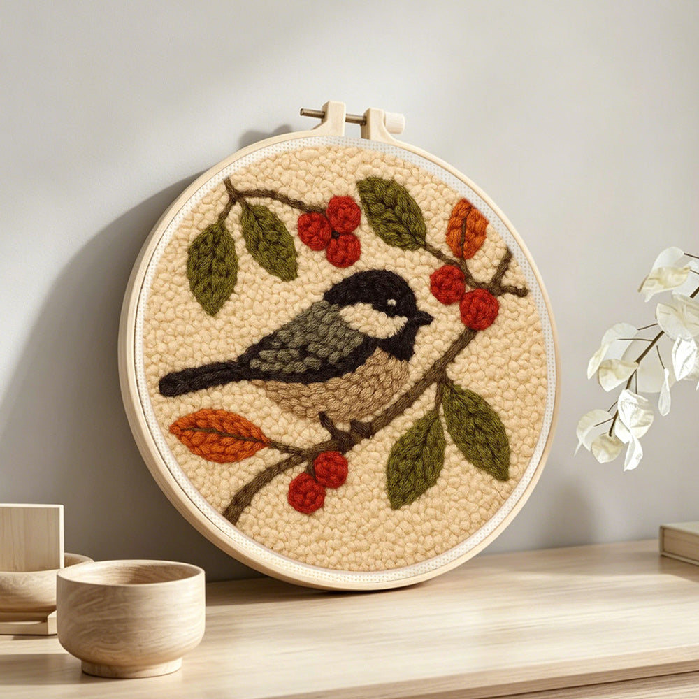 Bird and berries punch needle artwork displayed on a table