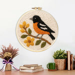 Finished bird on flowering branch artwork displayed on a wall