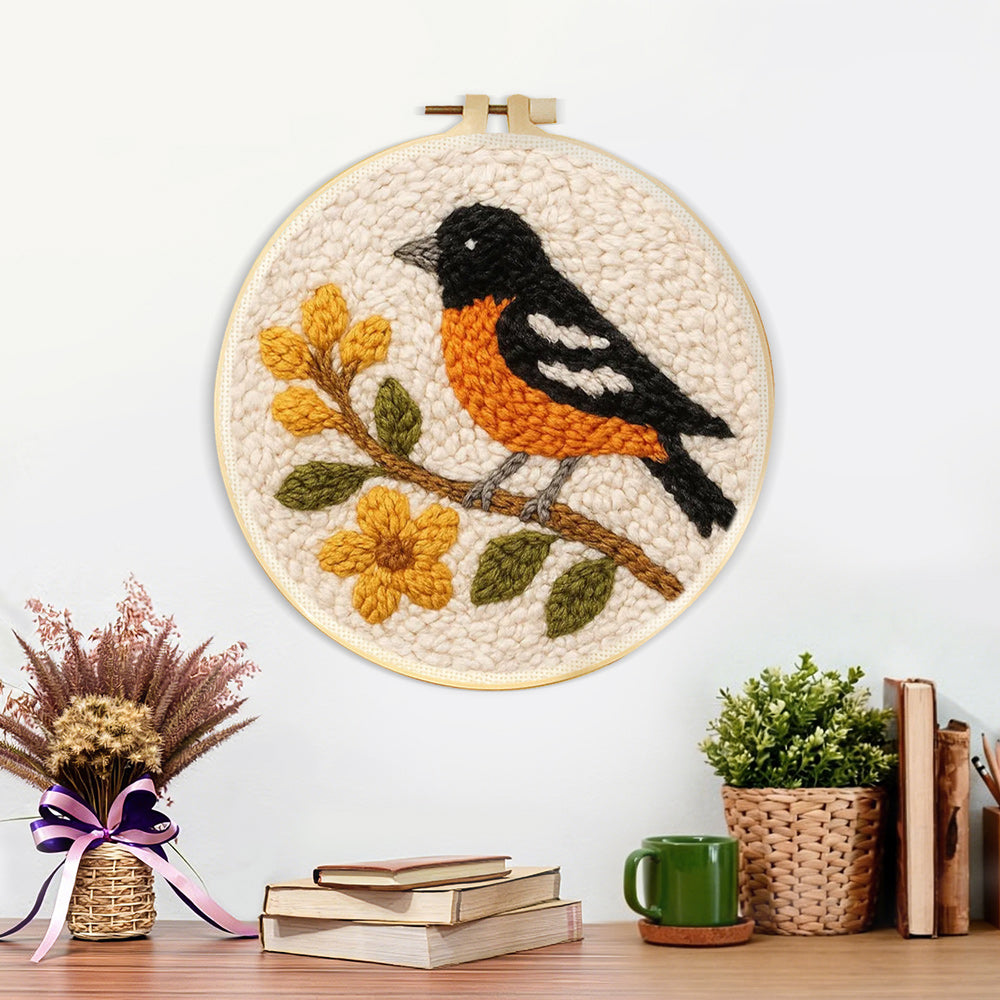 Finished bird on flowering branch artwork displayed on a wall