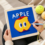Creating handmade bitten apple with big eyes punch needle artwork