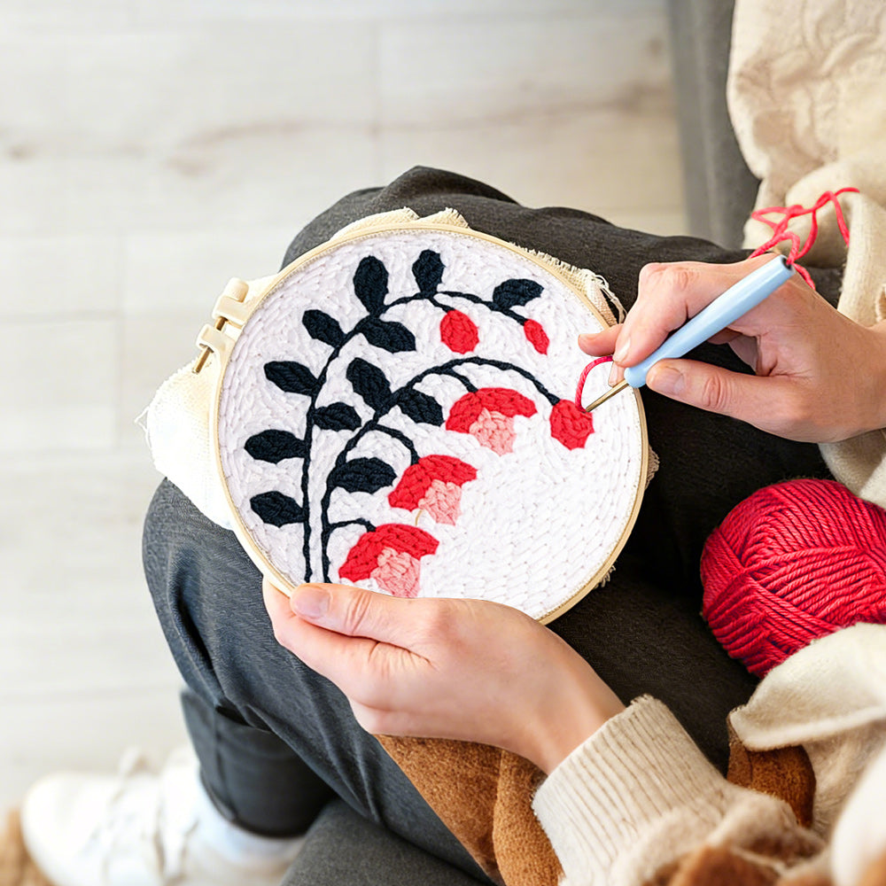 Creating handmade black branches with pink and red blooms punch needle artwork