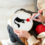 Creating handmade black cat and red ball of yarn punch needle artwork