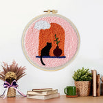 Finished black cat and terracotta vase artwork displayed on a wall