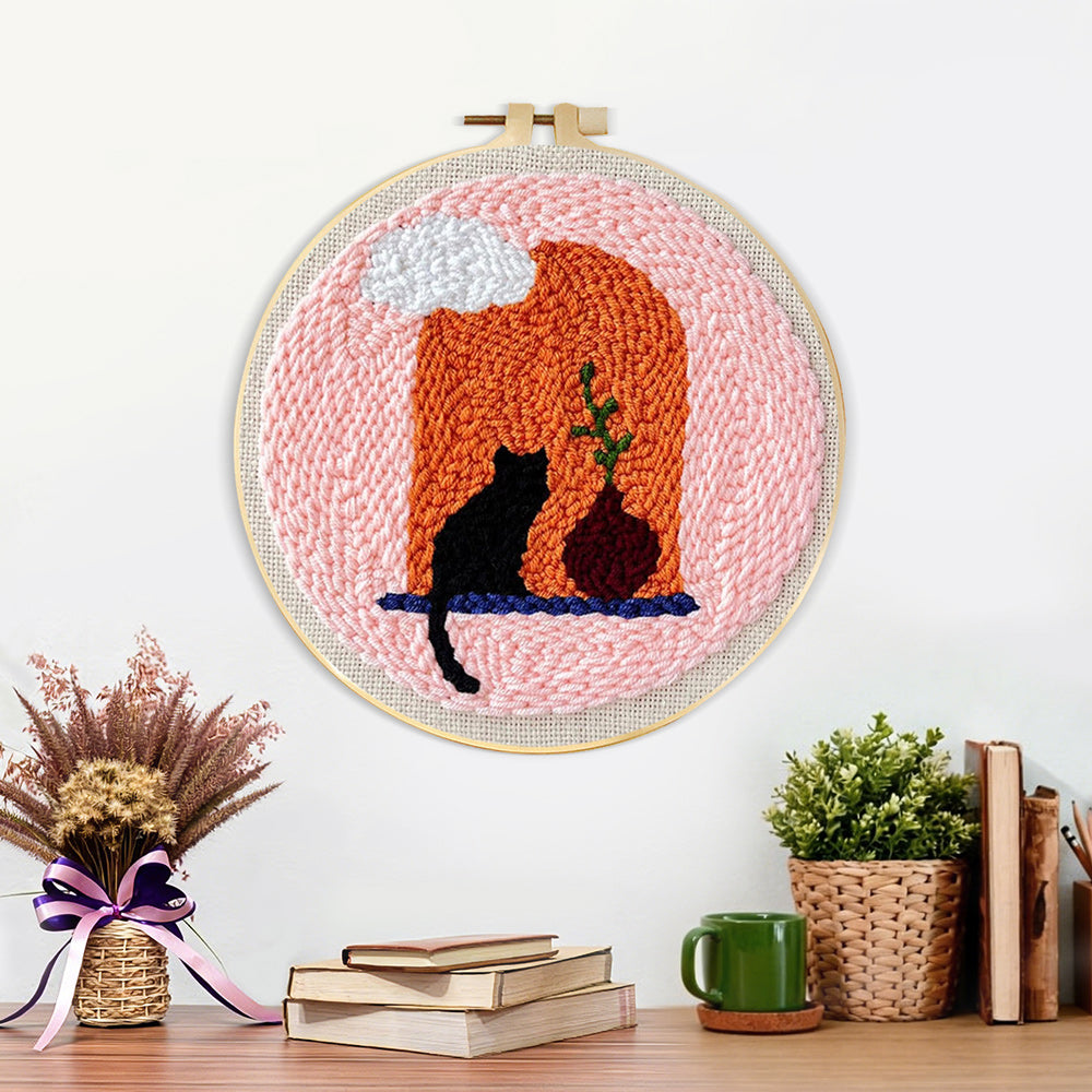 Finished black cat and terracotta vase artwork displayed on a wall