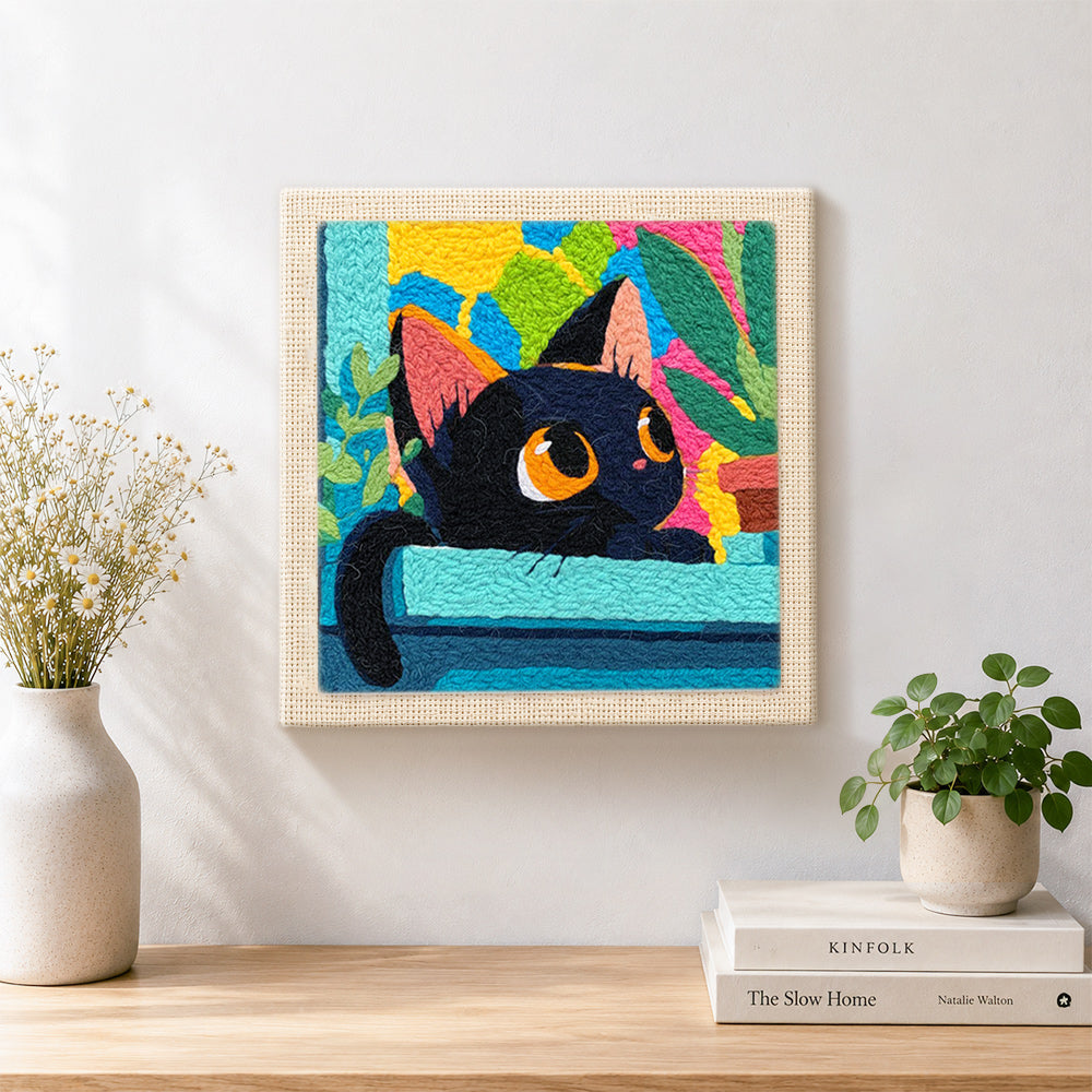 Finished black cat with colourful abstract leaves artwork displayed on a wall