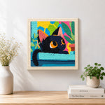 Finished black cat with colourful abstract leaves artwork displayed on a wall
