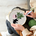 Creating handmade black cat with houseplant punch needle artwork